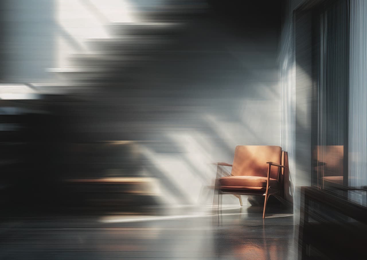 A leather armchair in a beam of afternoon light